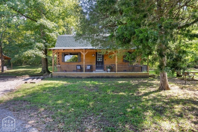 2 Star Falls Ln, Cherokee Village, AR 72529 - view of front of home featuring a front lawn, log exterior, covered porch, and roof with shingles