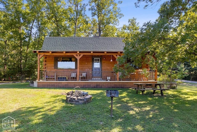 2 Star Falls Ln, Cherokee Village, AR 72529 - exterior space featuring a yard, a shingled roof, a fire pit, and covered porch