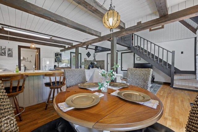 2 Star Falls Ln, Cherokee Village, AR 72529 - dining room featuring stairway, beam ceiling, and wood finished floors