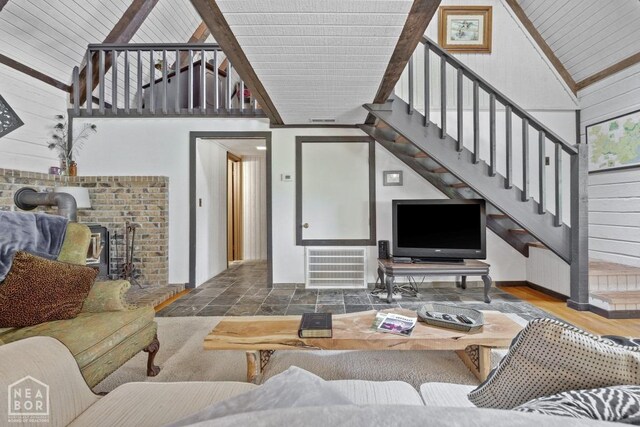 2 Star Falls Ln, Cherokee Village, AR 72529 - living area featuring wooden walls, stairs, visible vents, radiator, and high vaulted ceiling