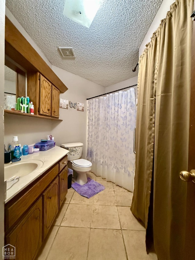 500 Oak St, Trumann, AR 72472 - full bath with a textured ceiling, vanity, tile patterned flooring, and a shower with curtain