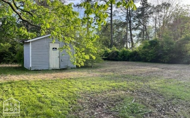 313 Olive St, Trumann, AR 72472 - view of grassy yard featuring a shed