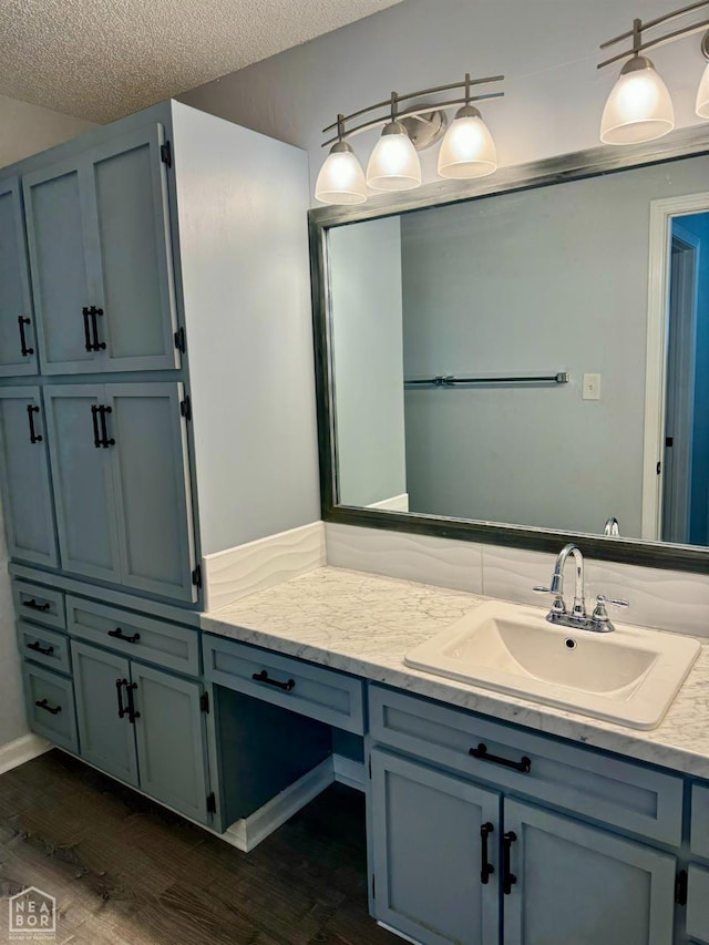 3426 Aggie Rd, Jonesboro, AR 72405 - bathroom with vanity, wood finished floors, and a textured ceiling