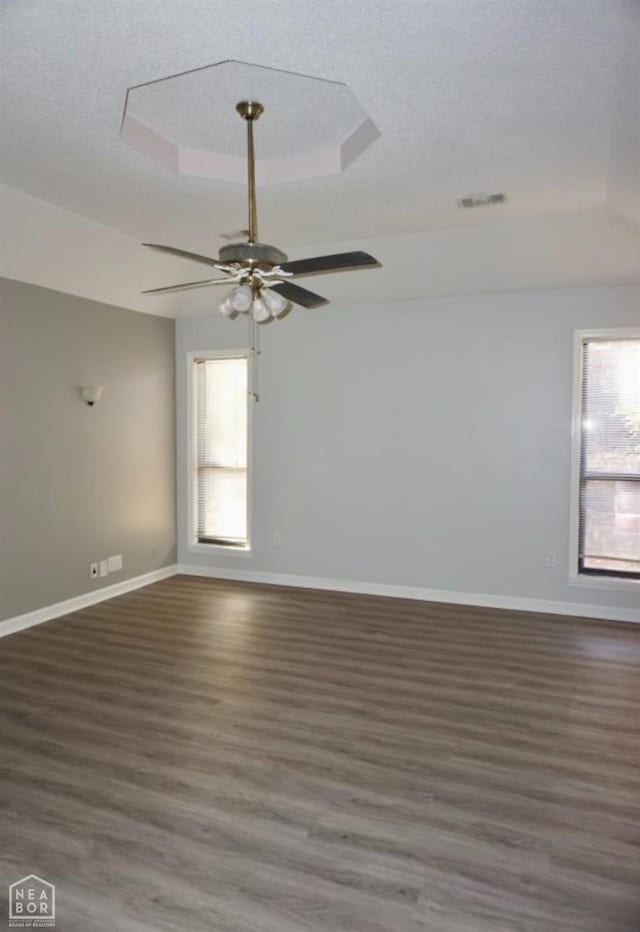 3426 Aggie Rd, Jonesboro, AR 72405 - unfurnished room featuring plenty of natural light, wood finished floors, a ceiling fan, baseboards, and a textured ceiling
