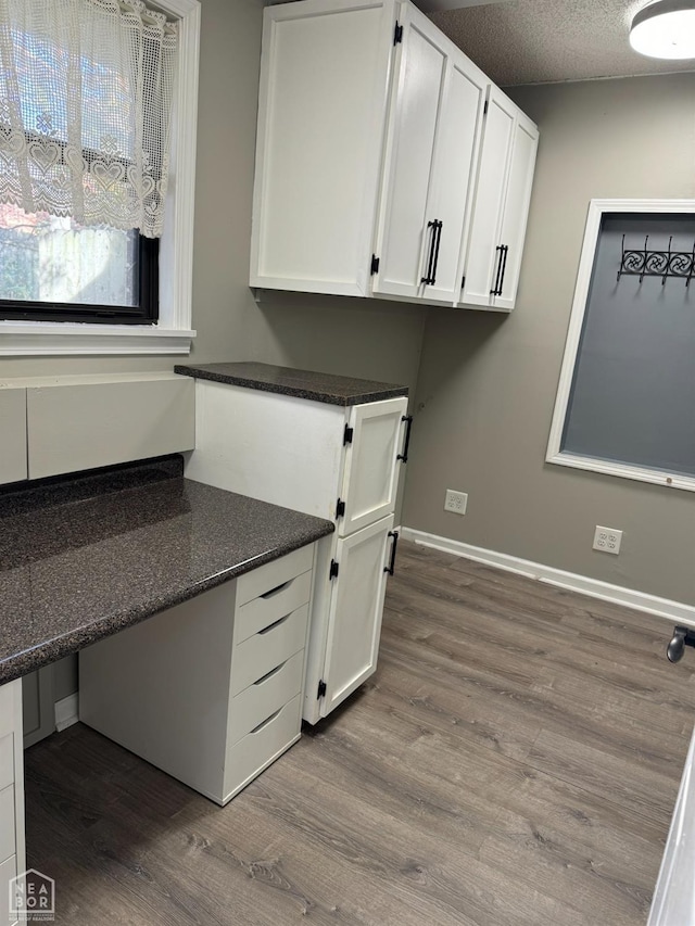 3426 Aggie Rd, Jonesboro, AR 72405 - unfurnished office featuring dark wood-style flooring, baseboards, and a textured ceiling