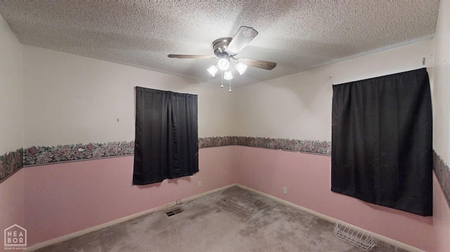 819 Northgate Dr, Osceola, AR 72370 - carpeted spare room featuring a textured ceiling, visible vents, a ceiling fan, and baseboards