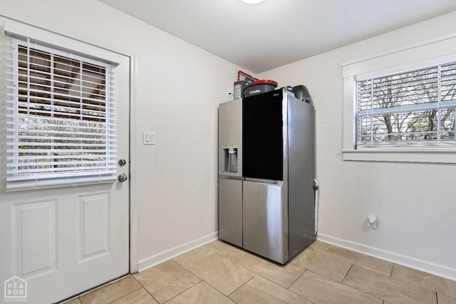 laundry area with baseboards