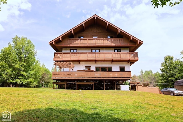  - exterior space with a yard, a deck, stucco siding, and a balcony