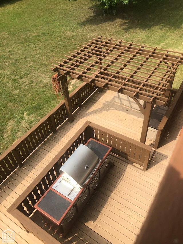  - wooden deck with a pergola and a lawn
