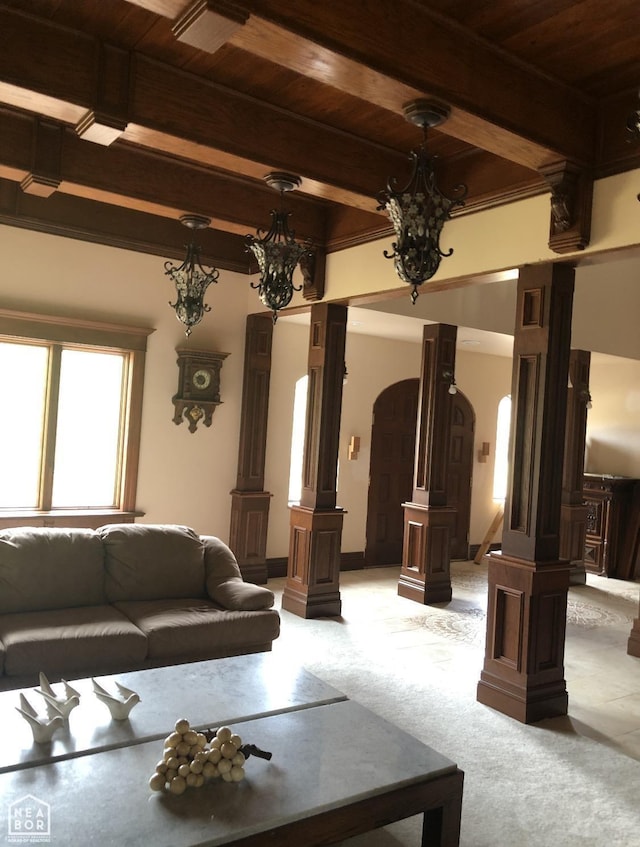  - living room featuring wooden ceiling, decorative columns, arched walkways, and light colored carpet