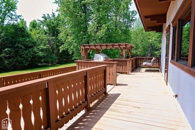  - wooden deck with a pergola and area for grilling