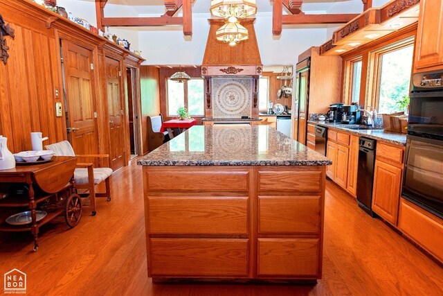  - kitchen with a sink, light wood-style flooring, a kitchen island, and plenty of natural light