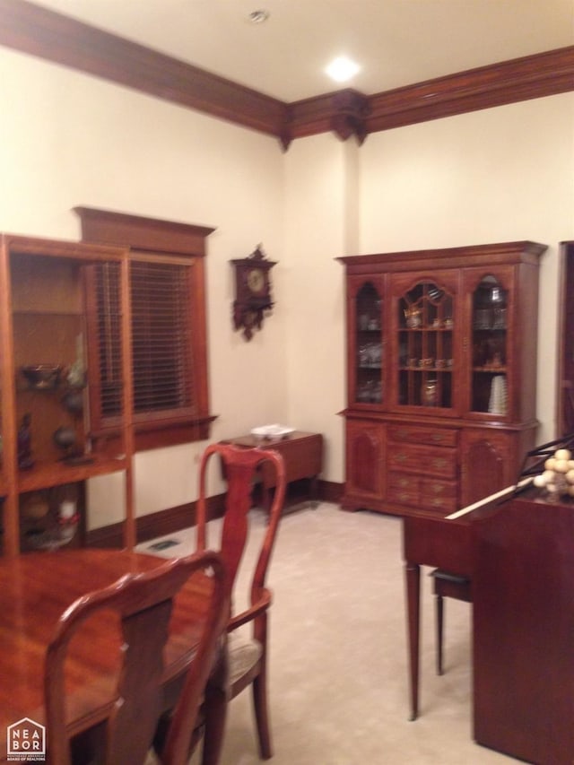  - carpeted dining area featuring ornamental molding