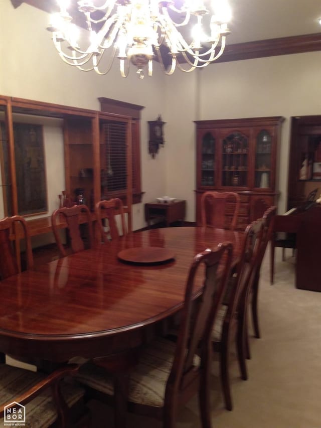  - dining space with crown molding, an inviting chandelier, and light carpet