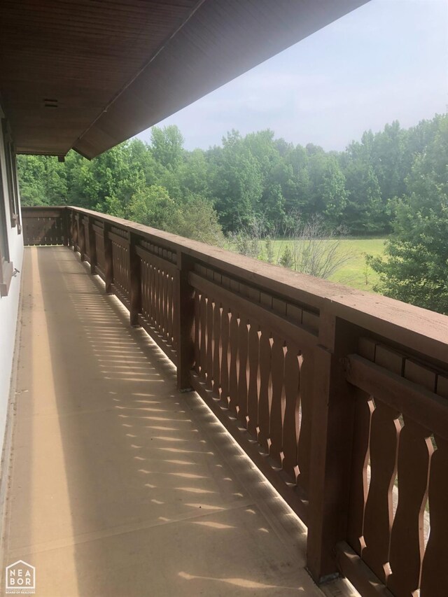  - balcony featuring a wooded view