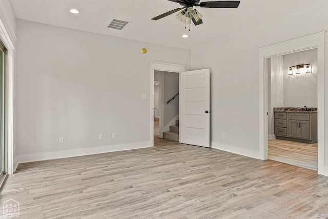 unfurnished bedroom with recessed lighting, visible vents, light wood-type flooring, and connected bathroom