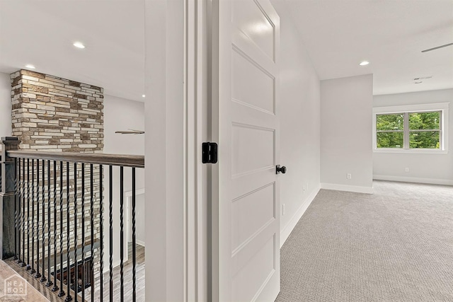 hallway featuring carpet flooring, baseboards, and recessed lighting
