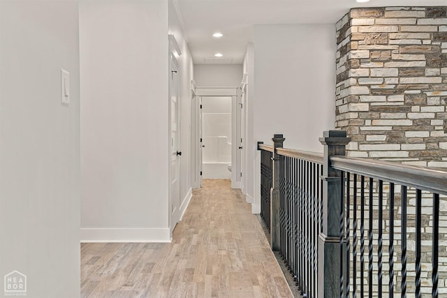 hallway with light wood-style floors, baseboards, visible vents, and recessed lighting