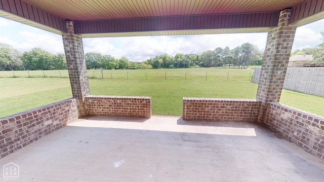 118 E Hills Dr, Bono, AR 72416 - fenced backyard with a patio area, a rural view, and view of scattered trees