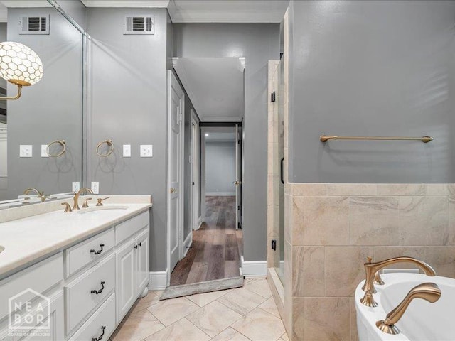 1005 Fairway, Jonesboro, AR 72401 - bathroom with a stall shower, vanity, a bath, crown molding, and tile patterned floors