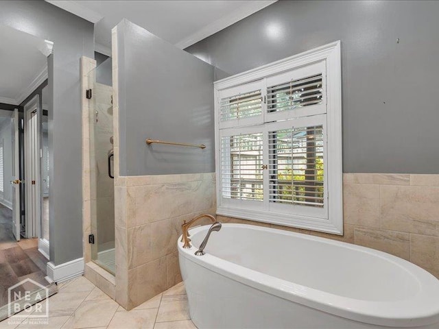 1005 Fairway, Jonesboro, AR 72401 - full bathroom featuring tile walls, a tub to relax in, a shower stall, and ornamental molding