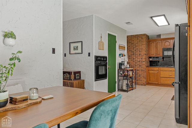 603 Arrowhead Dr, Jonesboro, AR 72401 - kitchen with black appliances, brown cabinets, light tile patterned floors, and a textured wall