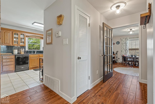 603 Arrowhead Dr, Jonesboro, AR 72401 - corridor with hardwood / wood-style flooring, a sink, baseboards, and french doors