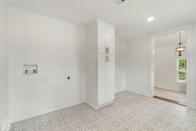 washroom with cabinet space, electric dryer hookup, baseboards, and hookup for a washing machine
