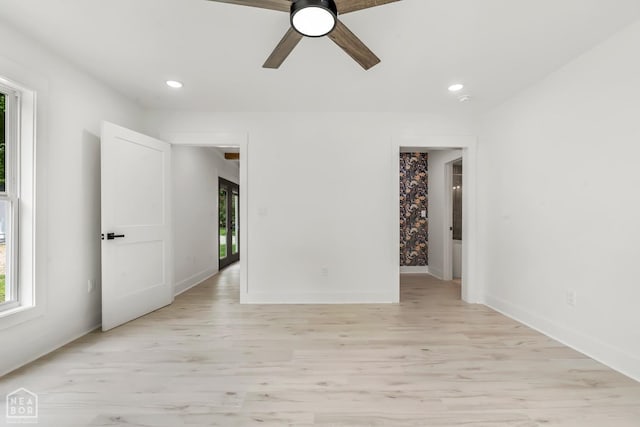 spare room with light wood-type flooring, a ceiling fan, baseboards, and recessed lighting
