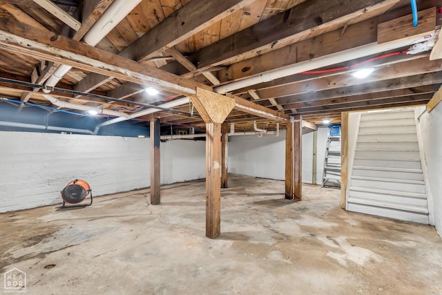 unfinished basement featuring stairs