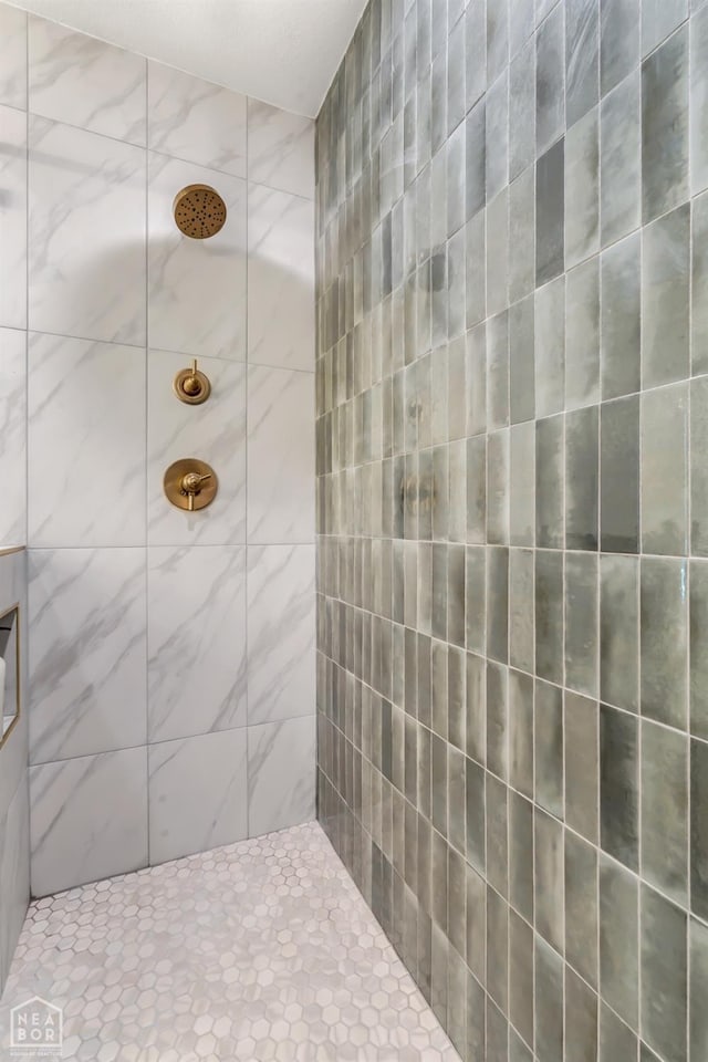 bathroom with tiled shower