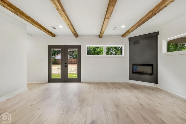 unfurnished living room with beamed ceiling, baseboards, french doors, and a fireplace