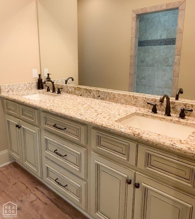 full bathroom featuring a sink and double vanity