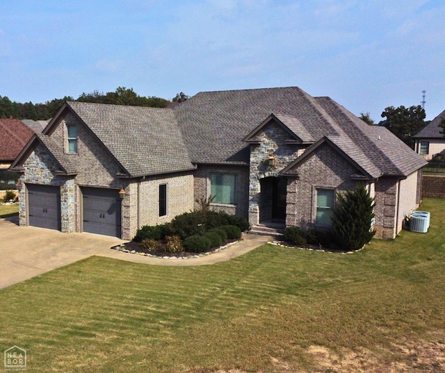 craftsman-style home with a front yard, an attached garage, cooling unit, concrete driveway, and brick siding