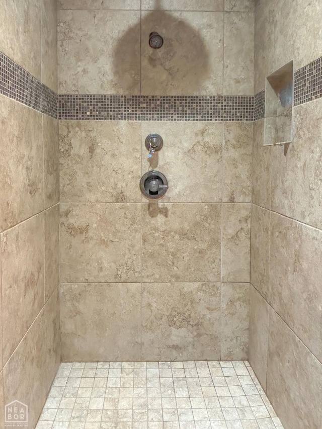 full bath with a tile shower