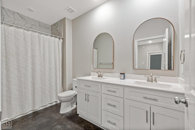 bathroom with a sink, toilet, double vanity, and concrete floors