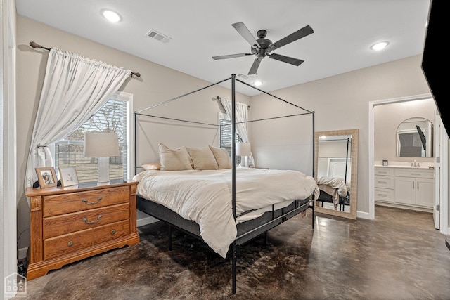 bedroom with visible vents, recessed lighting, connected bathroom, and finished concrete flooring