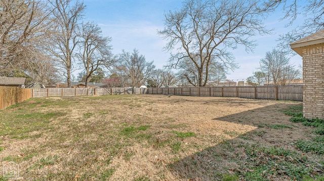 view of yard with a fenced backyard