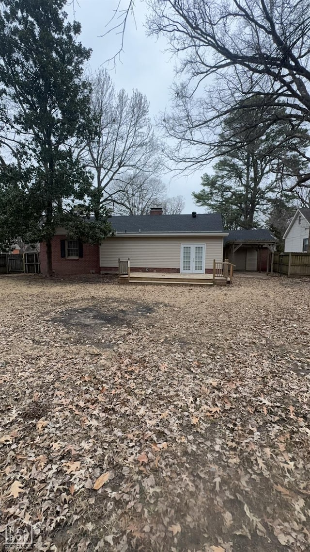 621 W Thomas Ave, Jonesboro, AR 72401 - rear view of house with fence, a deck, and a chimney