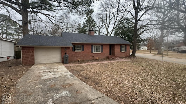 621 W Thomas Ave, Jonesboro, AR 72401 - ranch-style home featuring concrete driveway, roof with shingles, a chimney, an attached garage, and brick siding