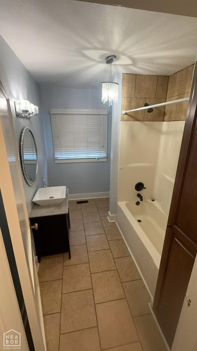 621 W Thomas Ave, Jonesboro, AR 72401 - bathroom with an inviting chandelier, shower / washtub combination, vanity, tile patterned floors, and baseboards