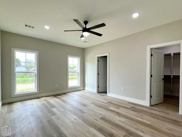 1217 Stella Ln, Trumann, AR 72472 - unfurnished bedroom with baseboards, light wood-type flooring, recessed lighting, a walk in closet, and ceiling fan