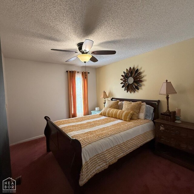 bedroom with dark carpet, a textured ceiling, and a ceiling fan