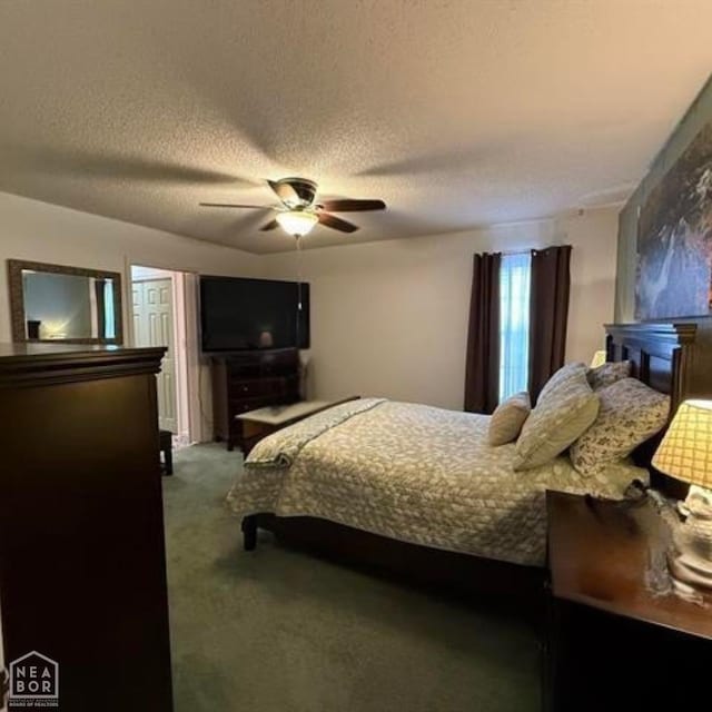 bedroom with ceiling fan, carpet flooring, and a textured ceiling