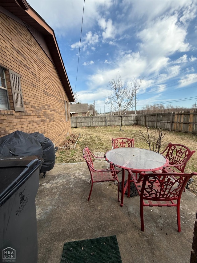 view of patio with a fenced backyard and outdoor dining area