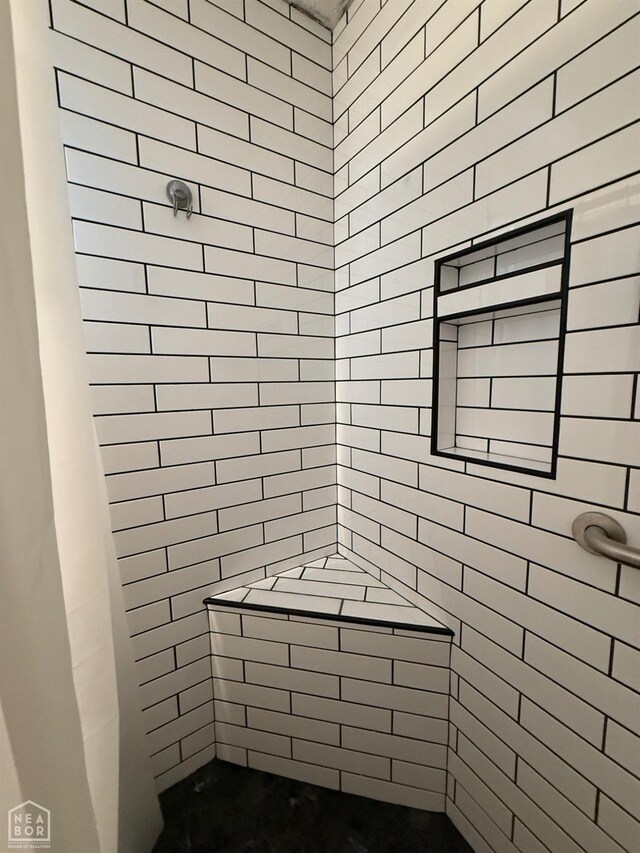 full bath with a tile shower