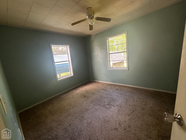 unfurnished room with baseboards, ceiling fan, a healthy amount of sunlight, and carpet