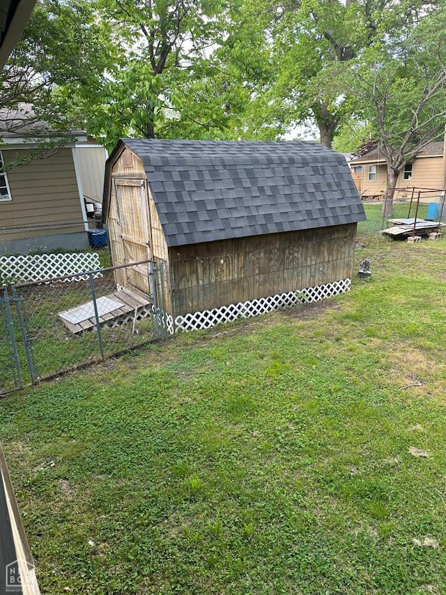 view of shed featuring fence