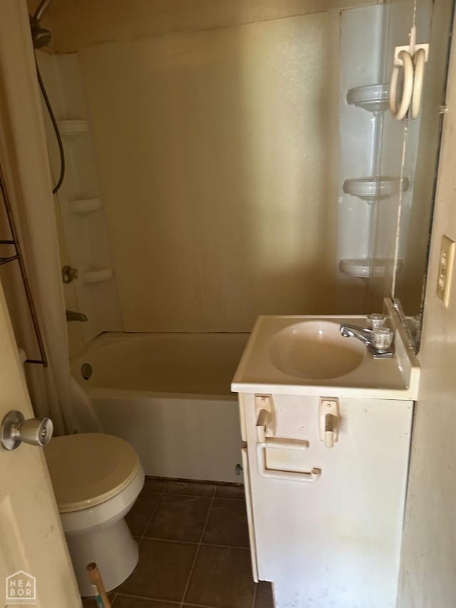 bathroom featuring vanity, tile patterned flooring, toilet, and shower / washtub combination