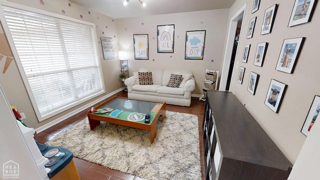 living area featuring wood finished floors and baseboards